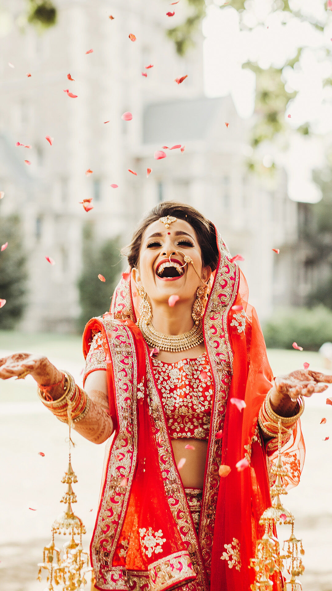 Joyful bride tossing flowers in the air during wedding celebration